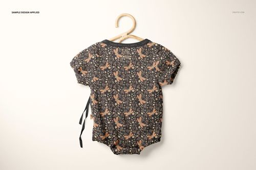 Muslin onesie mockup featuring a dark floral print, shown from the back on a hanger against a light background.