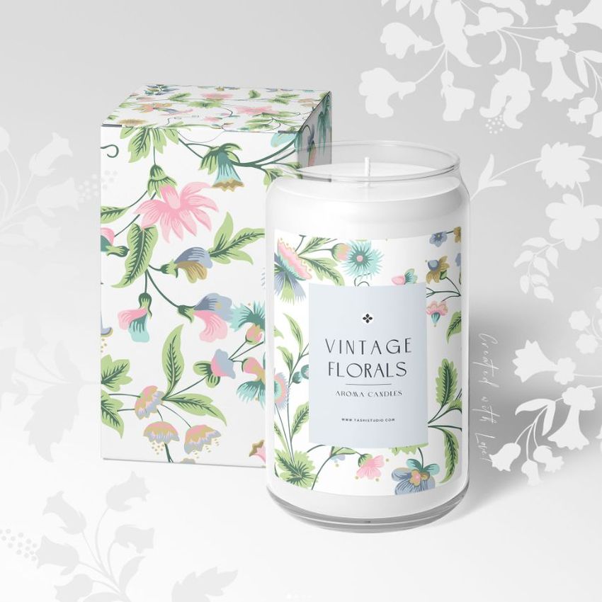 Can glass candle mockup featuring a floral-patterned box and matching candle label, displayed on a light background with floral graphics.