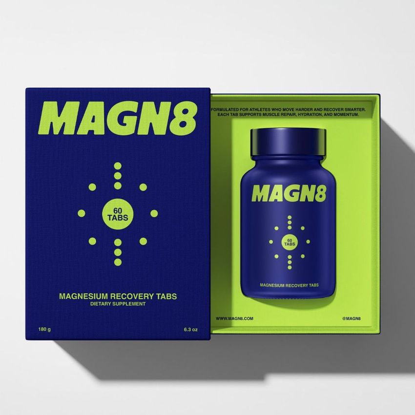 Cosmetics box packaging mockup featuring a blue box and matching bottle with bold yellow text, shown from above on a light surface.