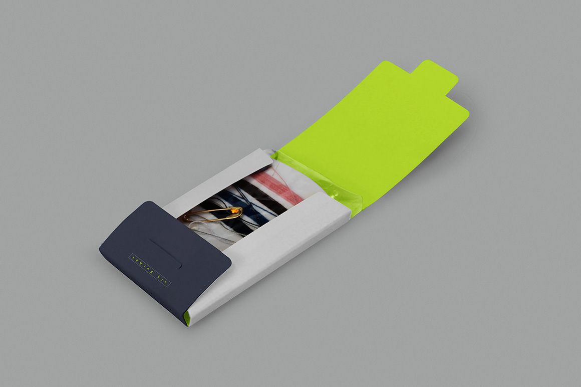 Sewing kit mockup displayed in an open rectangular package with gray, navy, and neon yellow colors on a neutral background.