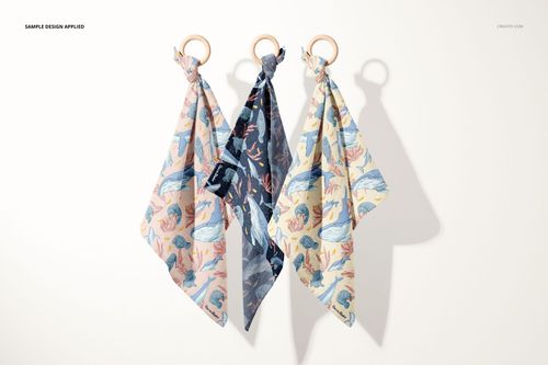 Front view of muslin cloth wooden teether mockup set, showing varied marine patterns and soft fabric textures on hanging cloths.