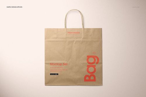 Natural kraft paper shopping bag mockup displayed flat, showing red text and graphics, with simple handles on top.
