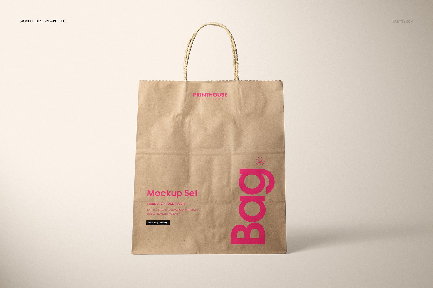 Front view of a natural kraft shopping bag mockup with twisted paper handles, featuring printed text in pink and black.