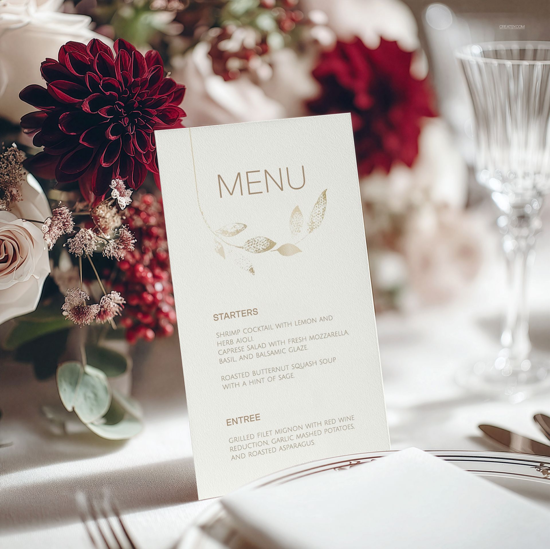 Elegant menu card mockup displayed on a wedding table with floral arrangements and glassware in the background.