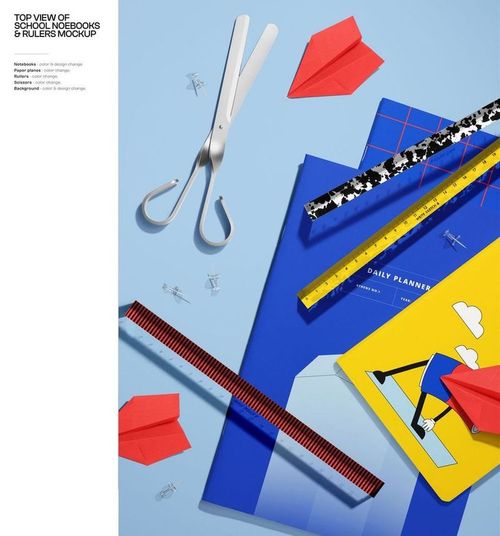 Top view of colorful stationery items including notebooks, rulers, scissors, paper clips, and red paper planes on a blue background.