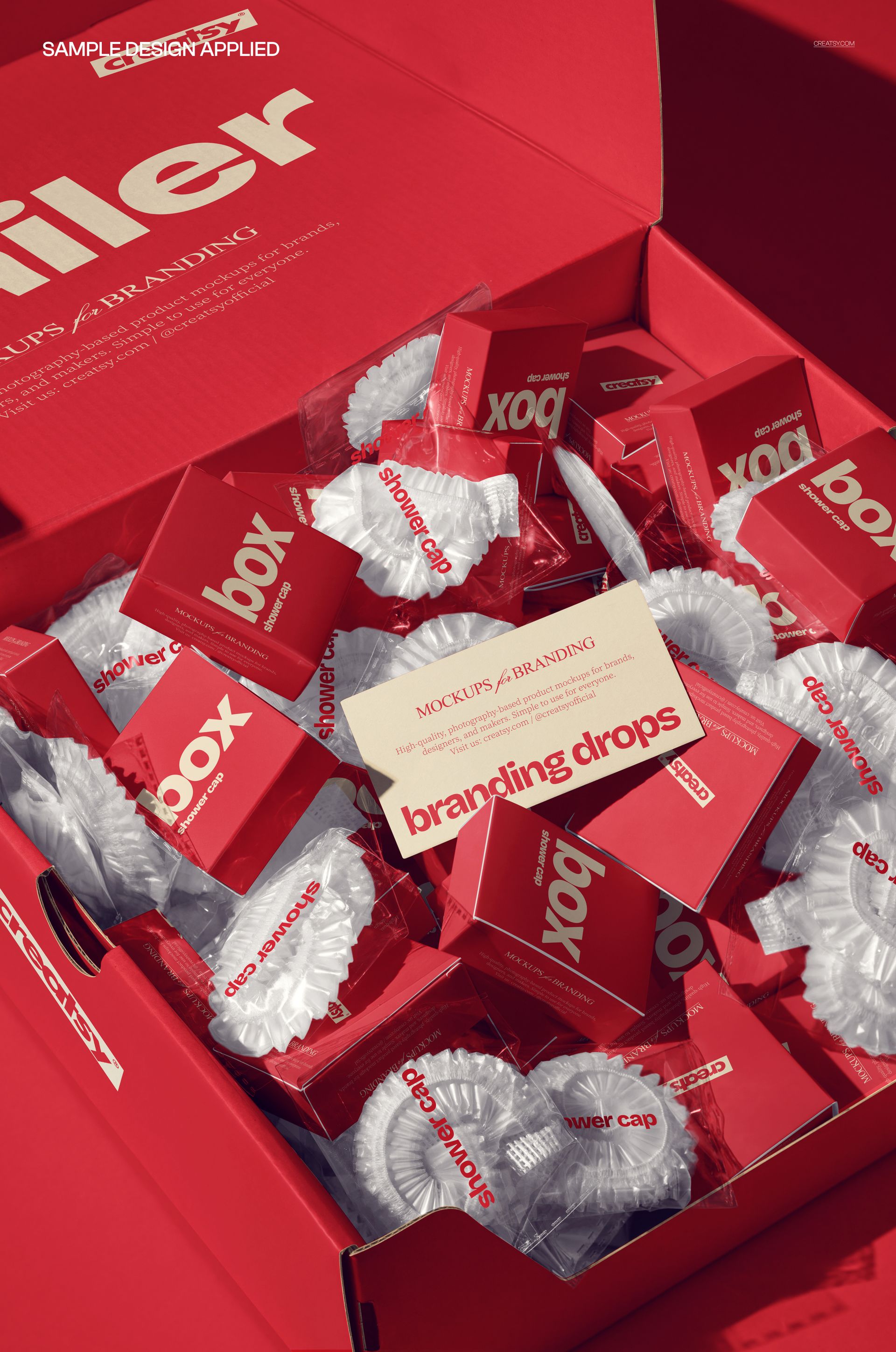 PSD mockup showing multiple hotel shower caps in clear wrappers and red packaging inside an open red mailing box.