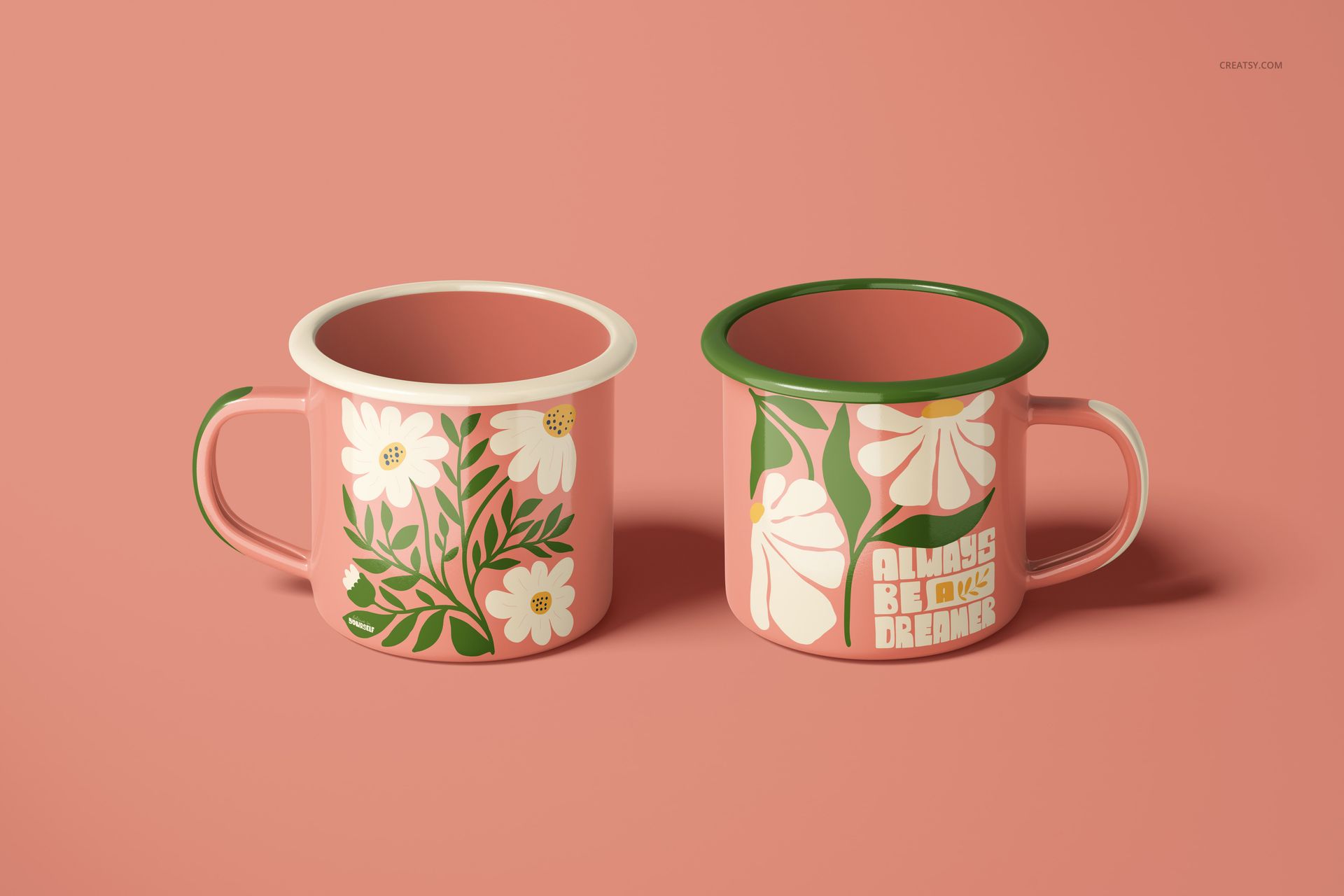 PSD mockup of enamel mugs with botanical designs and text, positioned together against a soft pink backdrop.