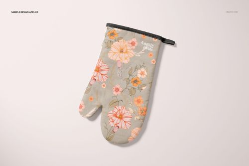 PSD mockup of a floral oven mitt featuring soft pastel colors and botanical designs, shown from above on a light surface.