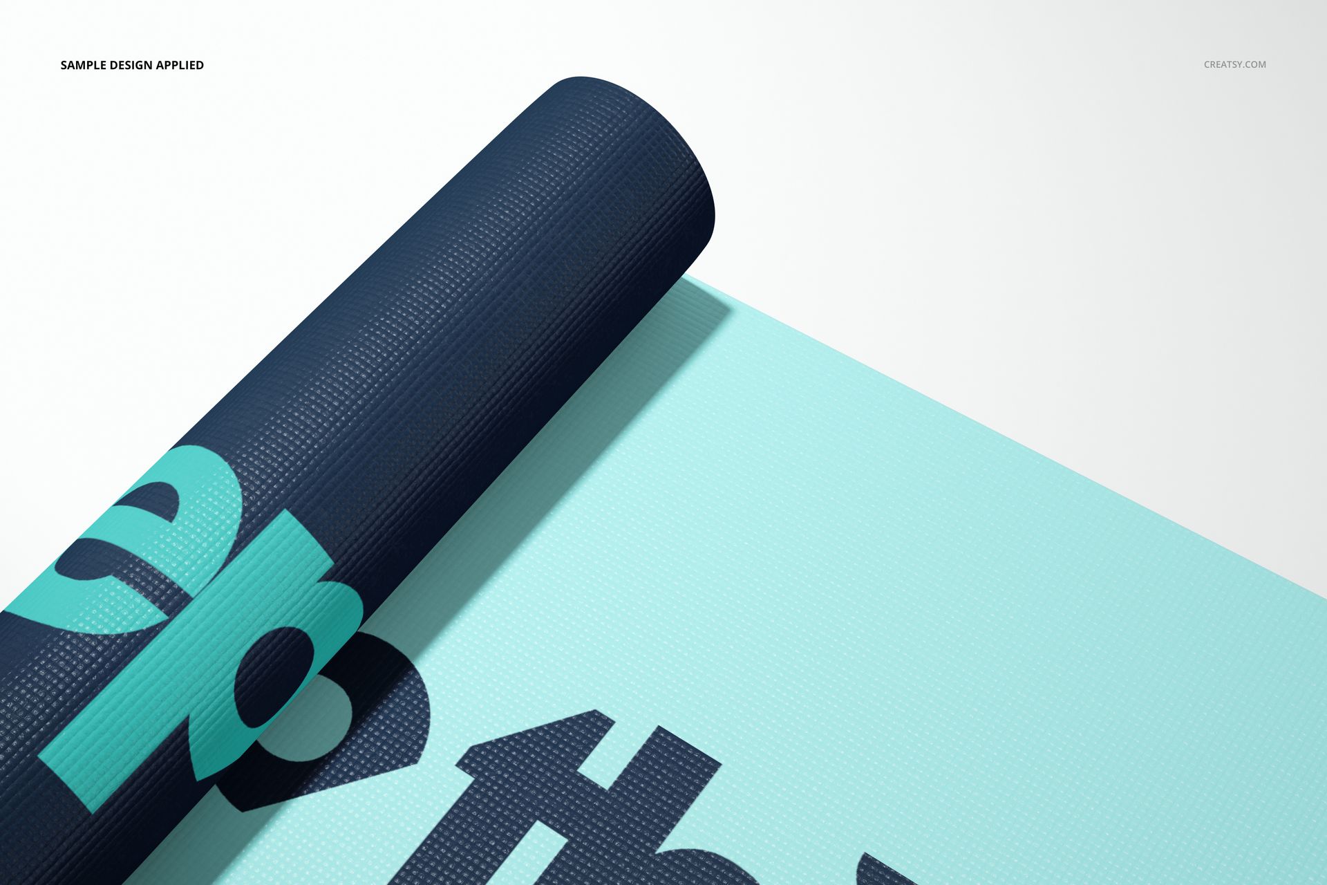 Exercise mat mockup with a rolled navy blue edge and large turquoise text on a light blue surface, top view.