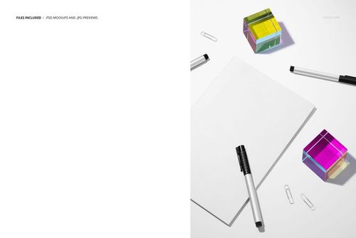 Stationery mockup featuring a plain notebook, pens, paper clips, and transparent acrylic cubes in vibrant colors.