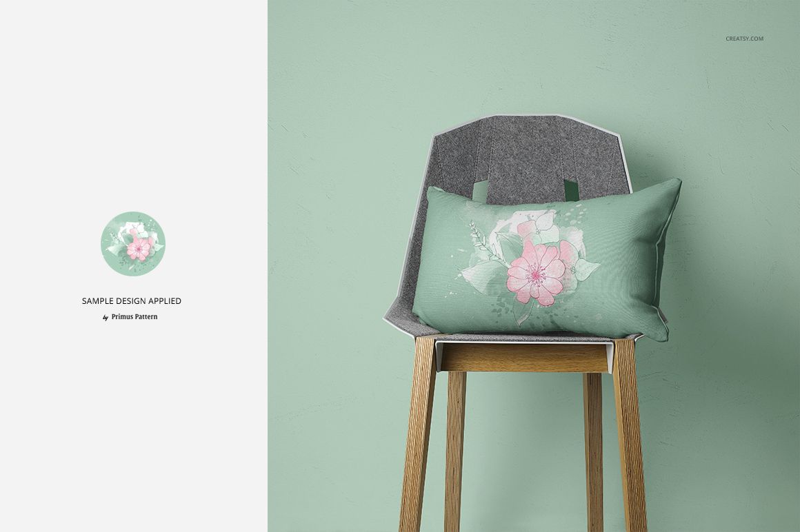 PSD mockup showing a green pillow with pink flowers placed on a modern wooden chair, mint green wall background.