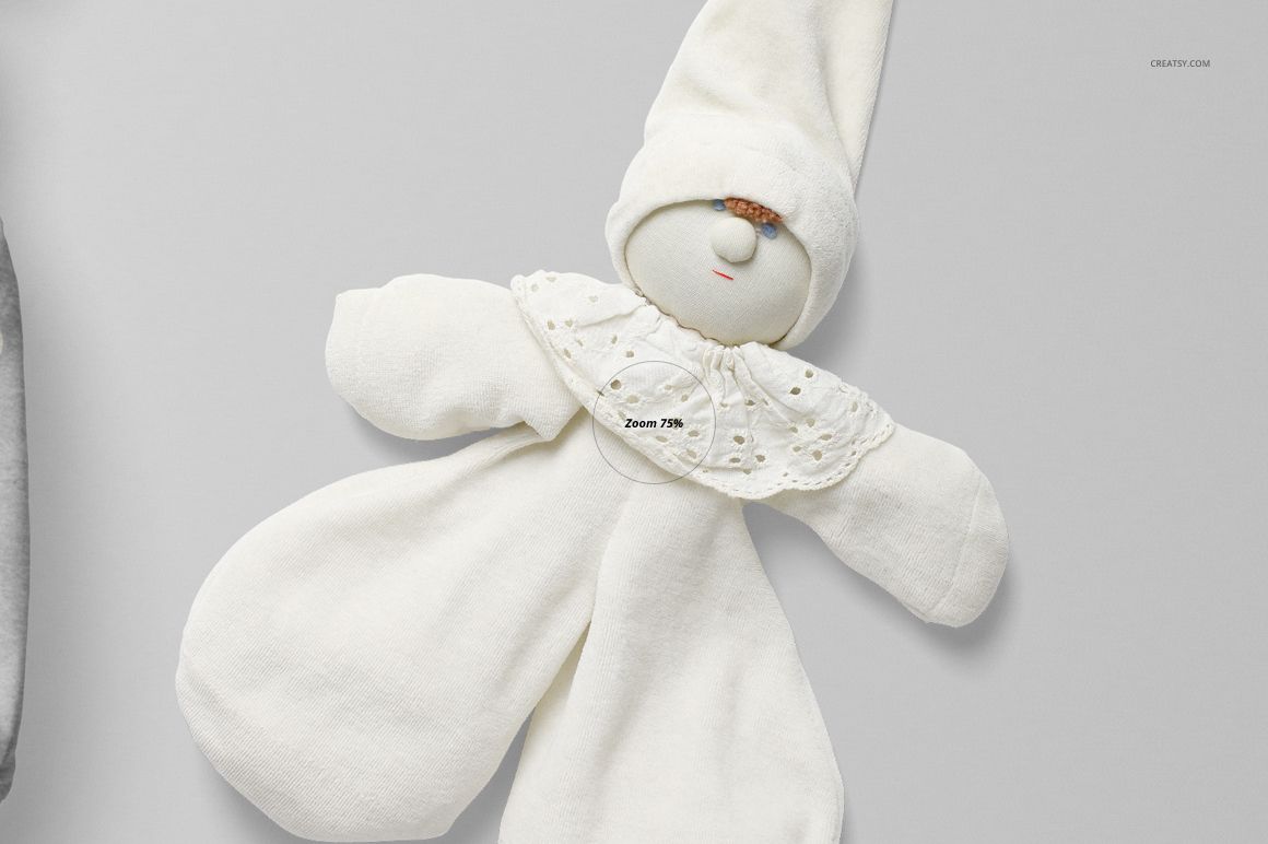 Front view of a baby romper mockup in soft white fabric, styled with a pointed hat and decorative collar on a neutral background.