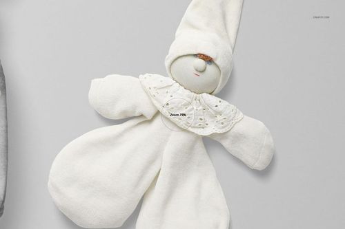 Front view of a baby romper mockup in soft white fabric, styled with a pointed hat and decorative collar on a neutral background.