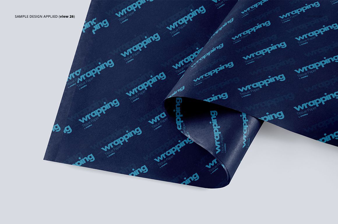 Dark blue wrapping tissue paper mockup with repeating turquoise text pattern, shown from a top angled view.