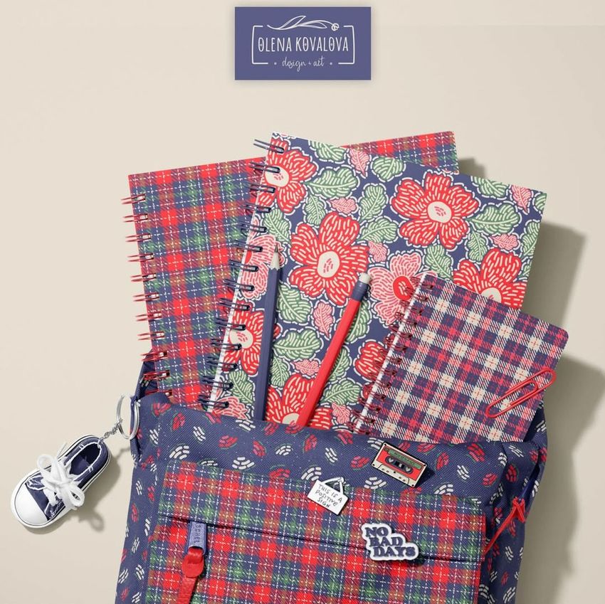School backpack mockup with spiral notebooks featuring colorful plaid and floral patterns, viewed from above on a beige background.