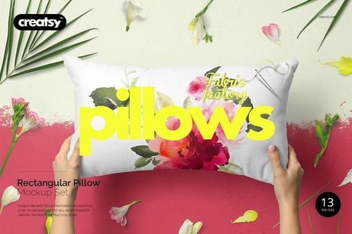 Lumbar pillow mockup featuring watercolor floral pattern, displayed upright with hands and decorative flower props.