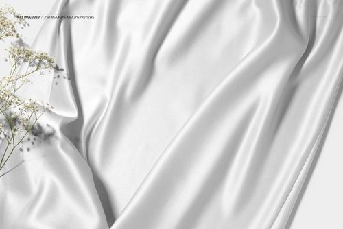 Detailed close-up of white satin silk fabric mockup, featuring elegant draping and gentle creases with small floral accents.