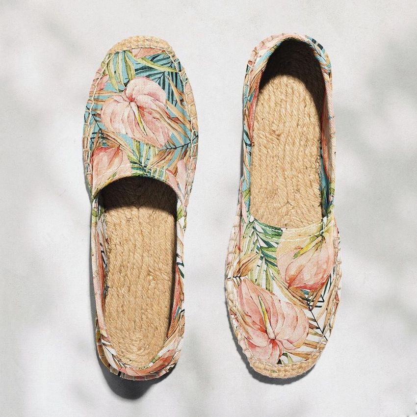 Canvas espadrilles mockup featuring a pair of shoes with a floral pattern, displayed from above on a light textured surface.