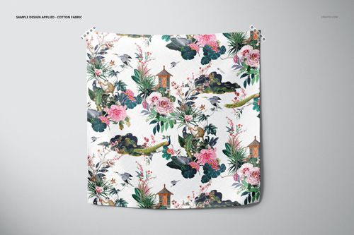 PSD mockup of a furoshiki fabric wrap, showing a vivid design with flowers, greenery, and small structures on white fabric.