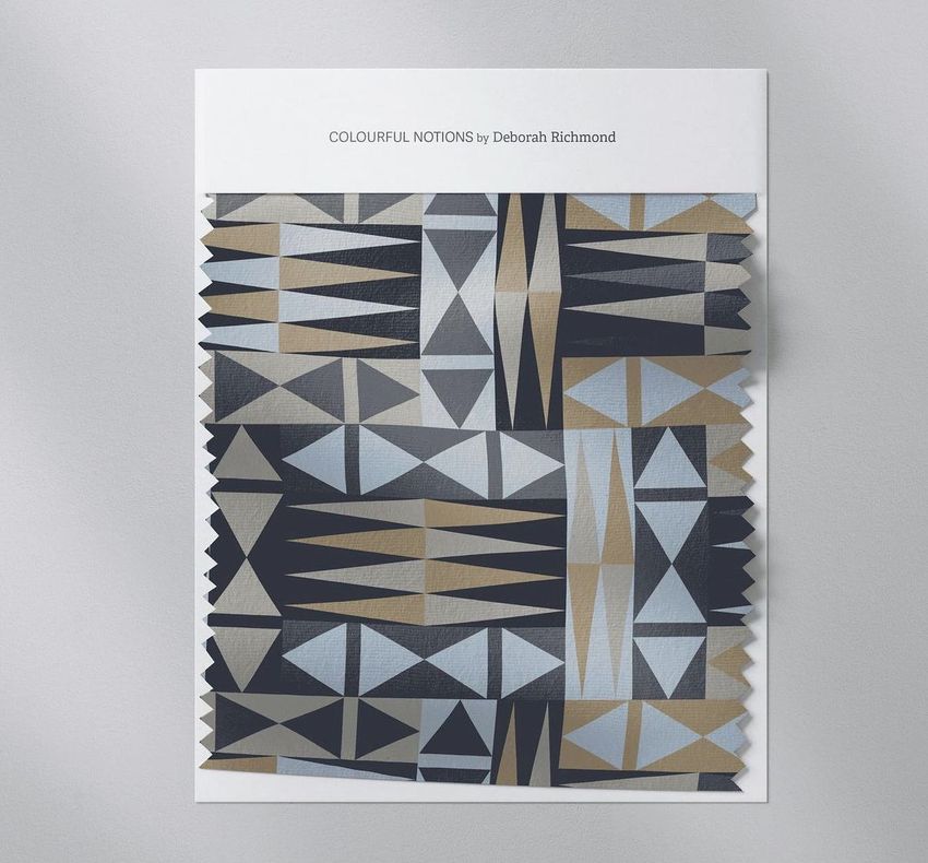 Fabric swatch mockup featuring a geometric pattern in black, gold, and gray tones, displayed on a white card background.
