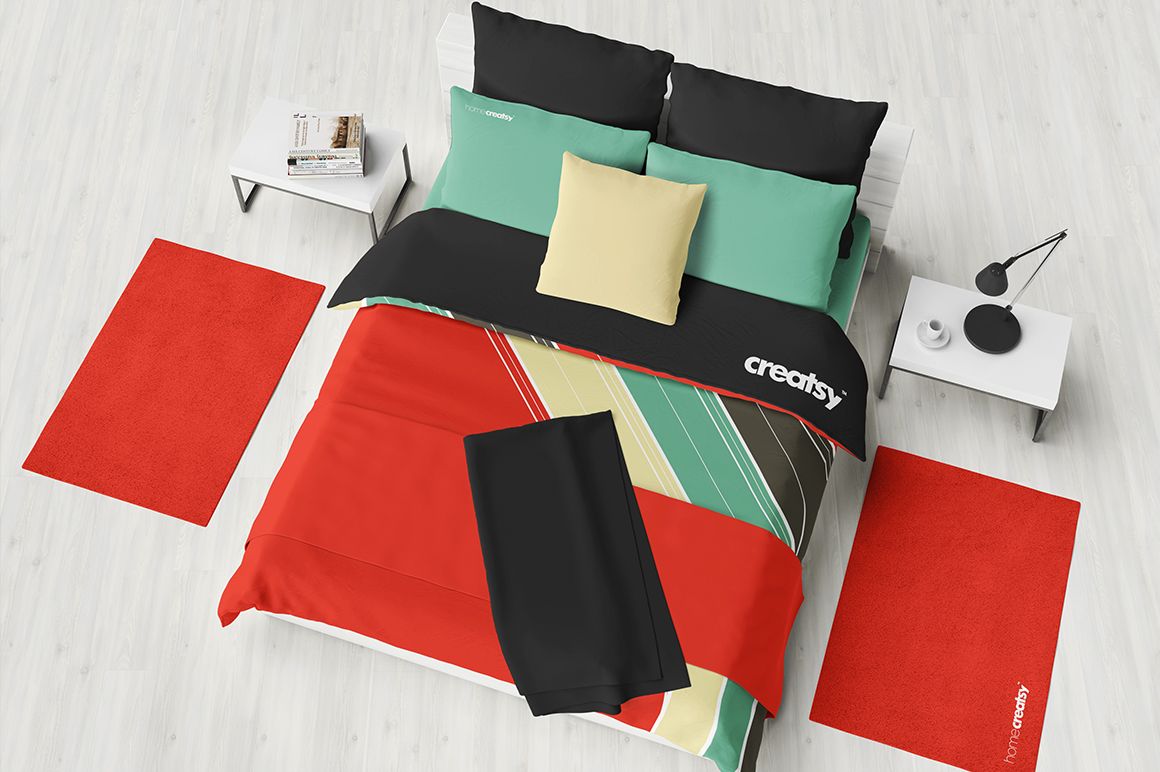 Top view of a bedding mockup set with colorful geometric sheet, quilt, pillows, blanket, and red rugs in a modern bedroom.