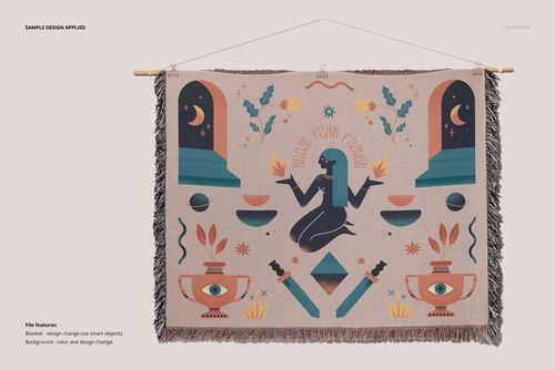 Fringed throw blanket mockup hanging on a wooden rod, decorated with abstract shapes and mystical motifs.