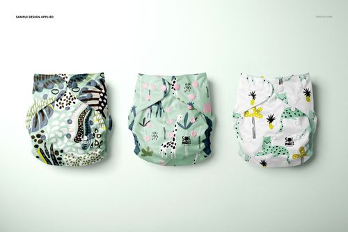 Front view of three baby cloth diapers in a mockup, each featuring different playful animal-themed designs and pastel colors.