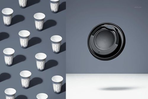 PSD mockup featuring rows of patterned paper cups on a blue surface and a single black lid hovering in mid-air.