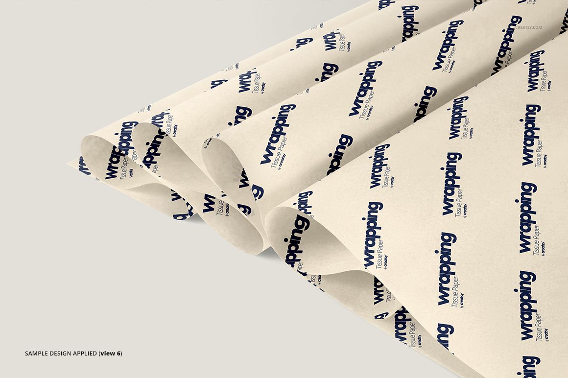 PSD mockup showing several overlapping wrapping tissue paper sheets with a simple blue and beige design.