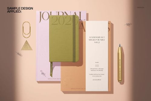Stationery mockup featuring a green pocket calendar notebook, planners, and accessories arranged on a light surface.