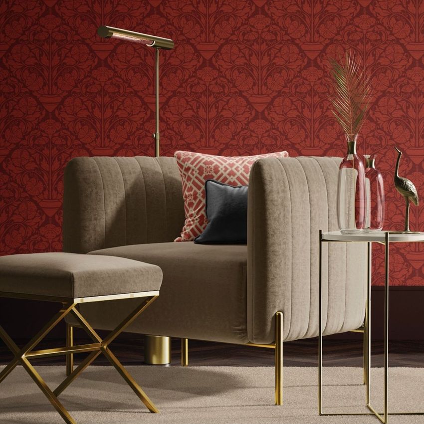 Velvet armchair and matching stool mockup in a modern living space, with gold accents and a red patterned wallpaper background.