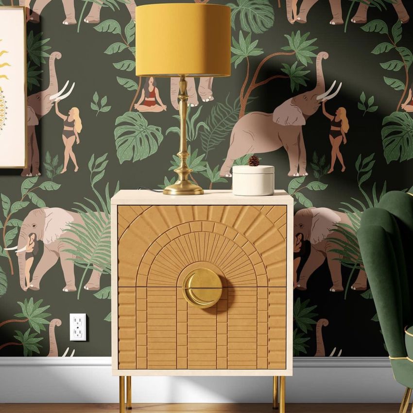 Drum lamp shade mockup with a yellow shade on a gold base, placed on a wooden cabinet in front of tropical wallpaper with elephants.