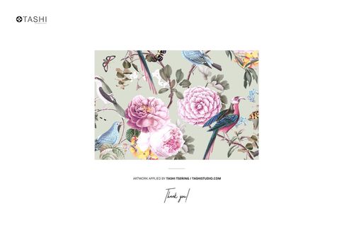 Lying fabric mockup with a floral and bird design, showing soft pink peonies, leaves, and blue birds on a pale surface.