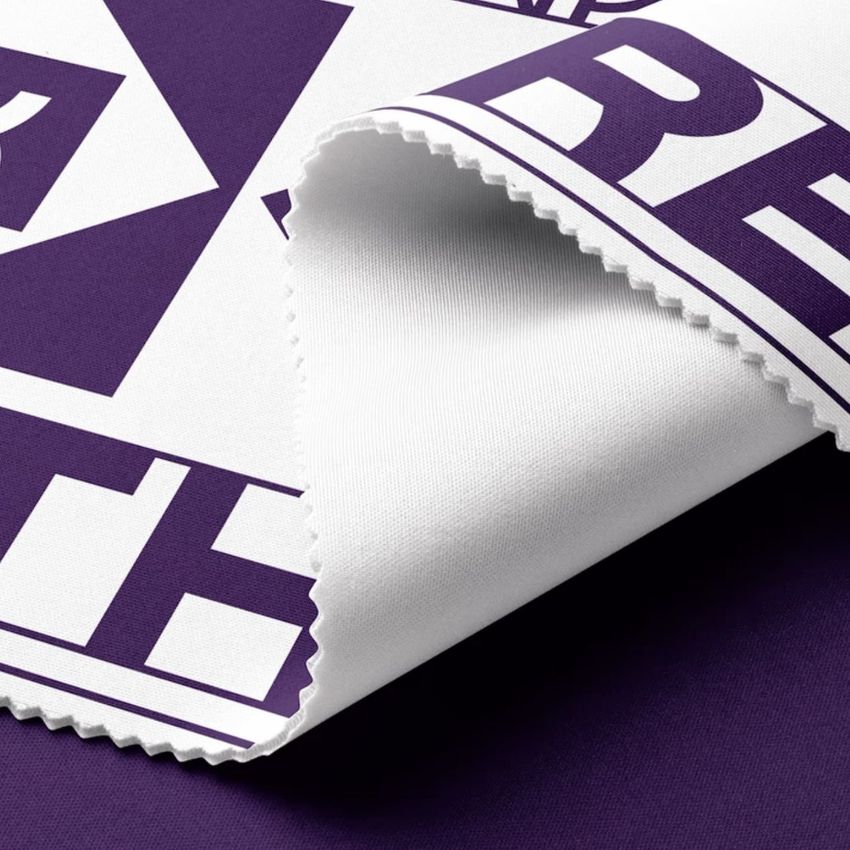 Scuba fabric mockup featuring a folded white textile with bold purple geometric text pattern, shown on a solid purple background.