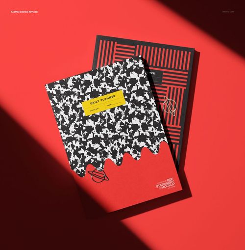 Top view of two stationery planners mockup, featuring bold graphic covers in black, white, and red on a red background.