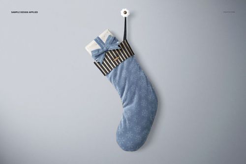 Velvet Christmas stocking mockup featuring blue fabric, snowflake motif, striped cuff, and gift inside, overhead perspective.