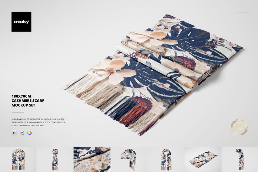 Folded cashmere scarf with a floral and leaf pattern in beige, blue, and red tones, shown from a top view on a white background.