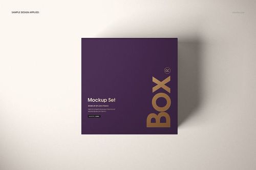 Top view of a magnetic gift box mockup featuring a purple lid with bold gold text, placed on a neutral surface.