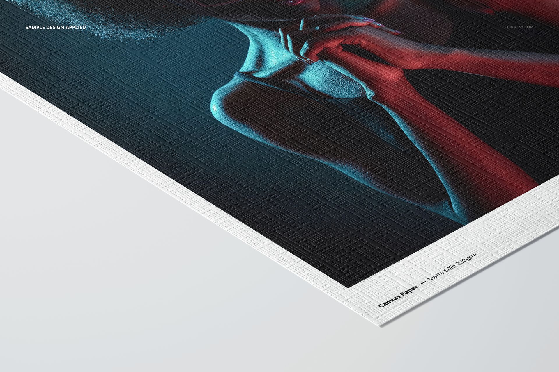 Close-up angled view of canvas paper mockup featuring a vivid portrait with blue and red lighting on textured surface.