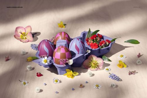 Front view of a mockup featuring a purple egg carton with patterned Easter eggs and colorful spring flowers scattered around.