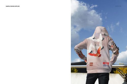 PSD mockup of an adult wearing a light-colored oversized hoodie with vibrant crane graphics, outdoor setting.