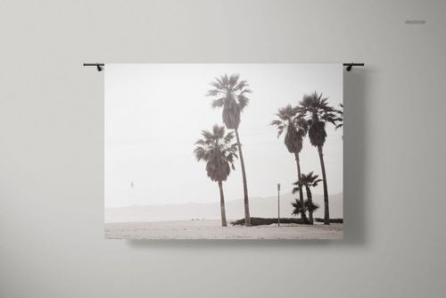 Large tapestry with palm tree print hanging on a light gray wall, shown in a realistic PSD mockup interior scene.