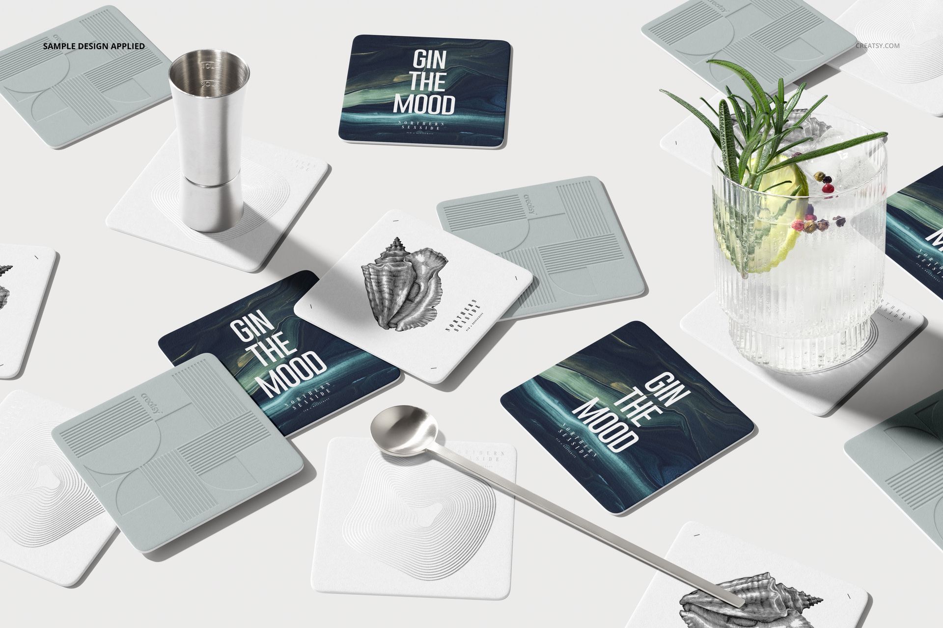 Top view of square coasters mockup set featuring graphic and text designs, styled with drinkware and bar tools.