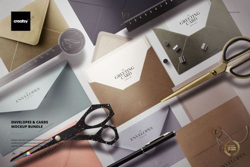 Stationery mockup scene showing envelopes and greeting cards in neutral colors, arranged with scissors and rulers.