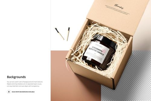 PSD mockup of an amber glass candle jar in a cardboard box with straw filling, viewed from above on a split background.