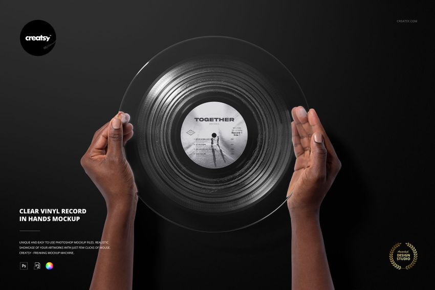 Top view of transparent vinyl record mockup held by hands, with visible label and circular grooves on black surface.