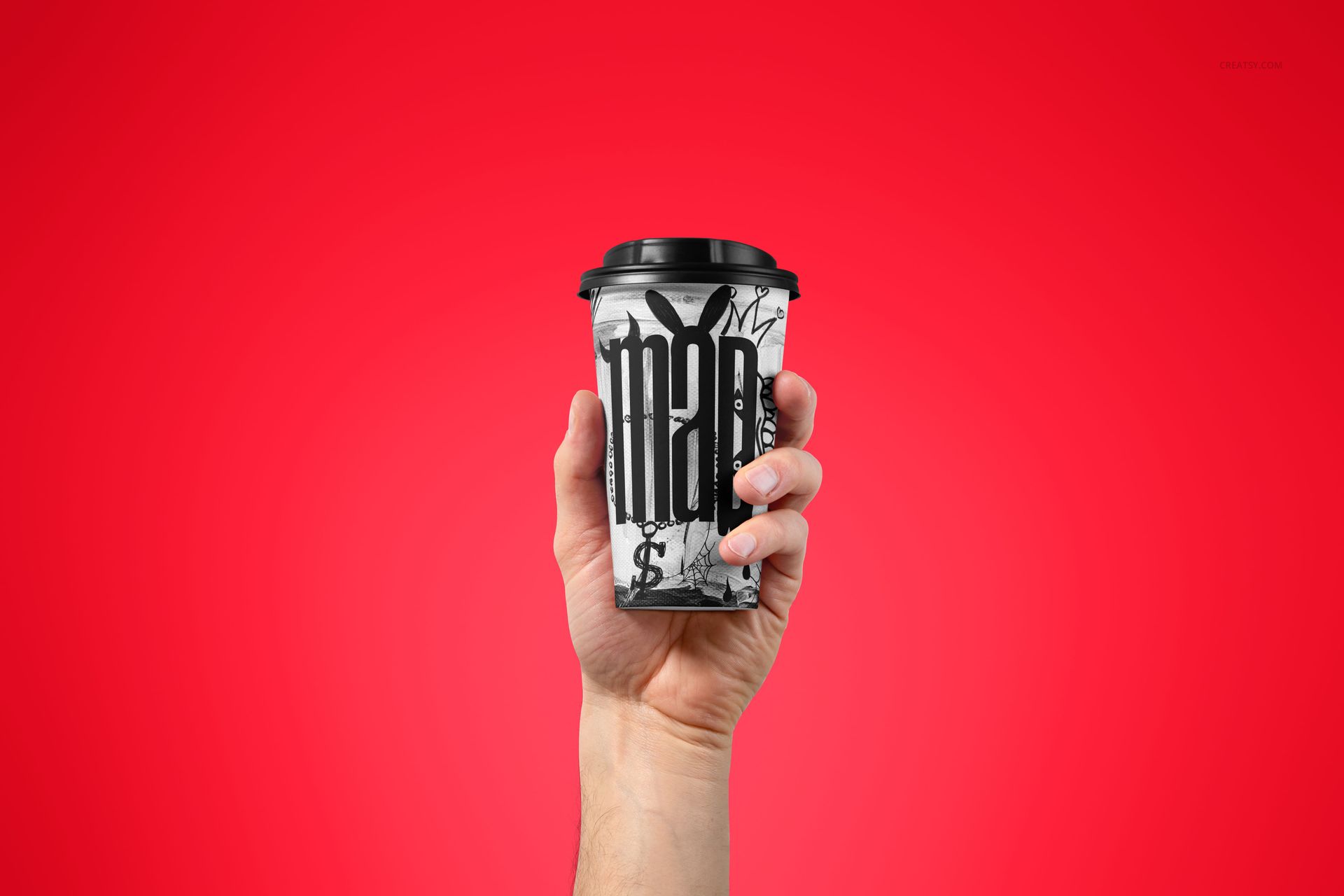 Close-up of a paper coffee cup mockup with black lid, held in a hand against a vibrant red backdrop.