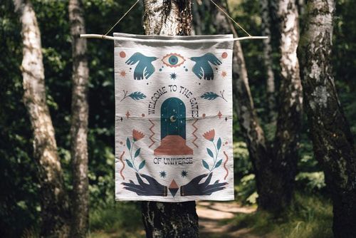 26x36 woven tapestry mockup displayed outdoors, featuring colorful patterns and text among birch trees.