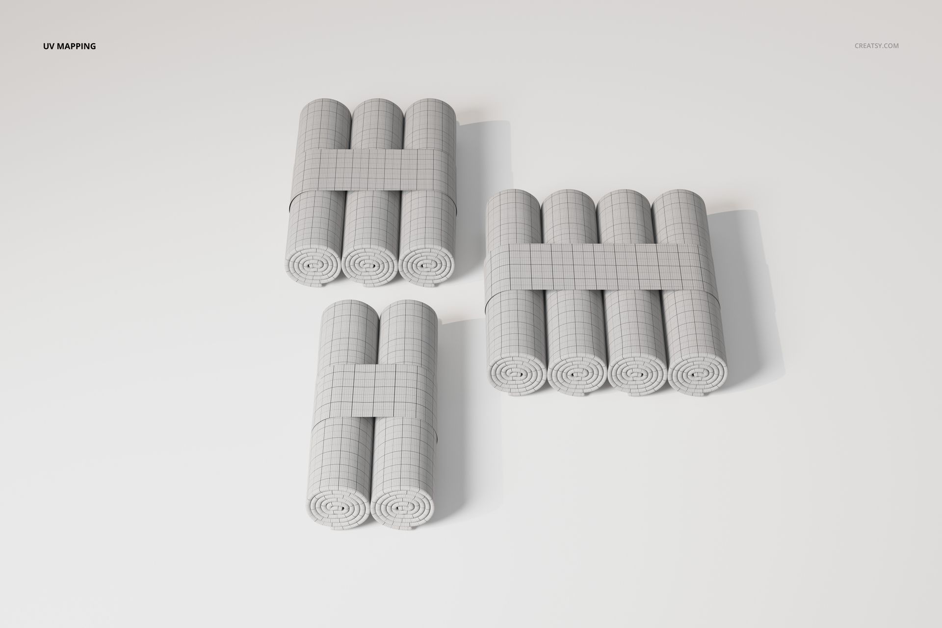 Three sets of changing pad paper rolls arranged in groups, featuring a grid pattern and viewed from above on a white surface.