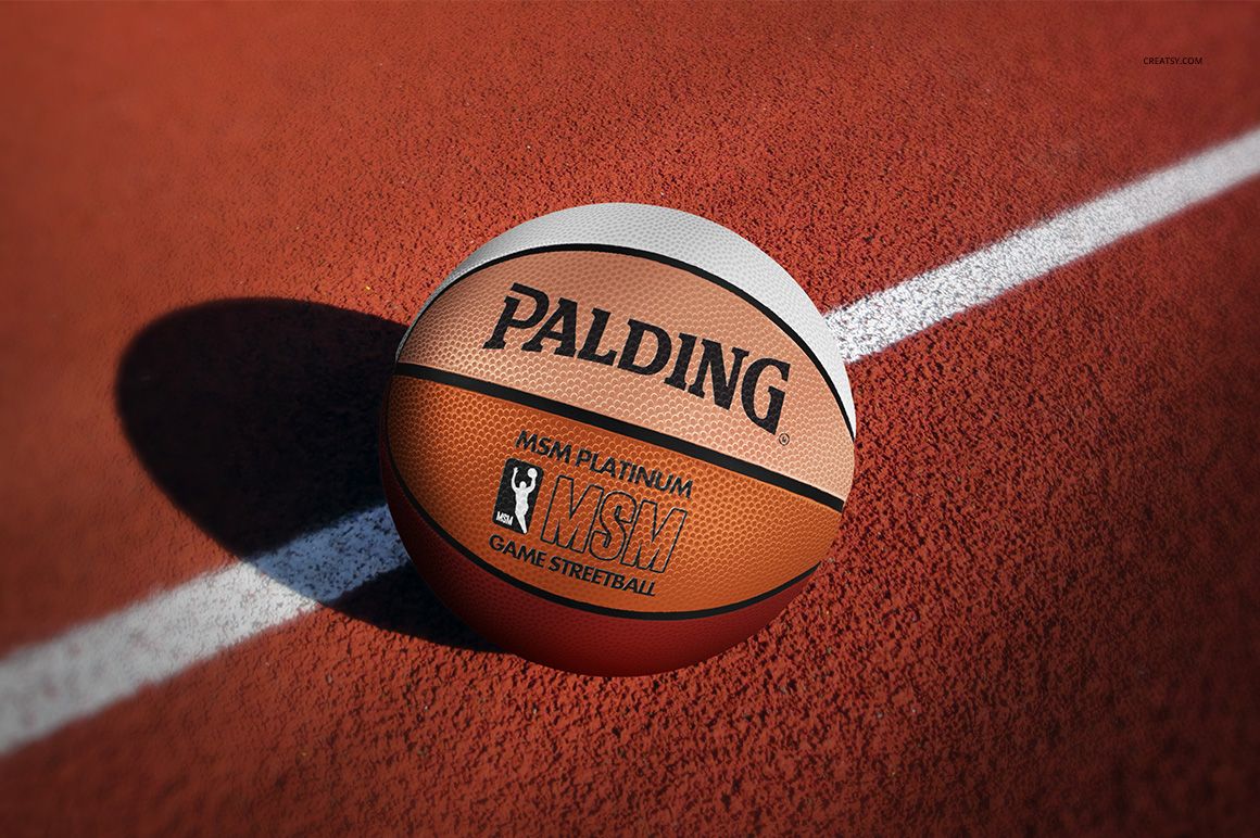 Realistic PSD mockup of a basketball ball featuring detailed surface and bold branding, placed on a sports field.